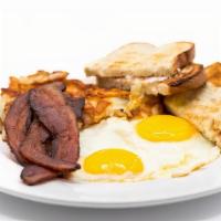 Two Egg Breakfast · Two Eggs Any Style, Thick Cut Hash Browns, Choice of Breakfast Meat and Toast or Biscuit