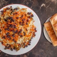 Qabeli Pulao · Served with rice, lamb shank, carrots & raisins and flat bread