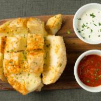Bloomin' Bread · Our version of cheesy bread topped with garlic butter and mozzarella cheese served with a si...