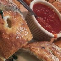 Spinach Bread · Fresh dough rolled with Mozzarella cheese and spinach, then baked golden brown and served wi...
