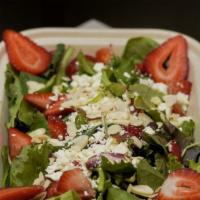 Strawberry Salad · Mix greens, Strawberries, almonds, feta cheese and raspberry walnut vinaigrette dressing.