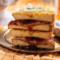 Pain Dore French Toast Aux Cornflakes Pb+J · classic pb+j sandwich with grape jelly, dipped in french toast batter, crusted in cornflakes...