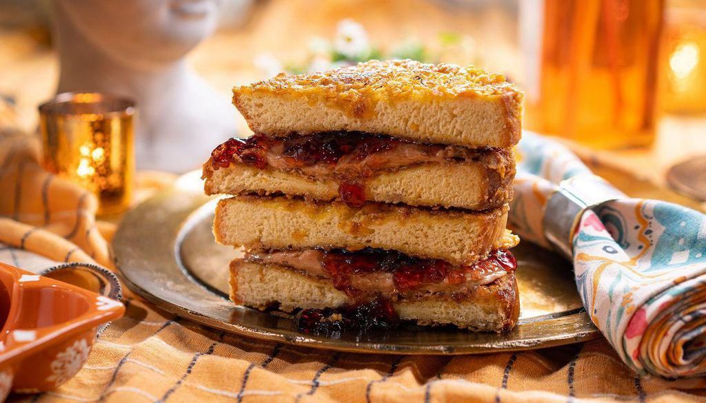 Pain Dore French Toast Aux Cornflakes Pb+J · classic pb+j sandwich with grape jelly, dipped in french toast batter, crusted in cornflakes, griddled until golden brown.