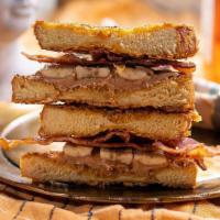 Pain Dore French Toast Americian · griddled cornflake crusted brioche french toast, peanut butter, bacon, bananas, honey