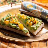 Avocado Toast Classique · mashed avocado mixed with organic chives, organic heirloom tomato, balsamic dressing on hous...
