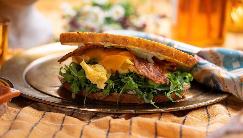 Delux Bacon Sourdough Sandwich  · sourdough, bacon, cheddar, egg, lemon herb aioli, arugula