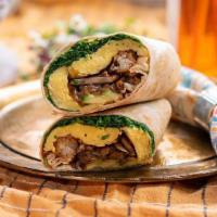 Classique Veggie Breakfast Wrap · flour tortilla rolled up + stuffed with 2 eggs, tater tots, avocado, caramelized onions, mus...
