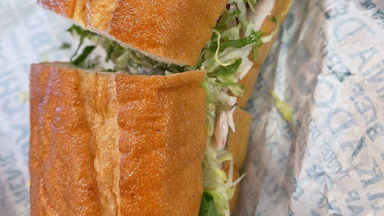 Turkey Club · Turkey breast with bacon and swiss cheese on a French baguette. Includes mayo, tomato and lettuce.