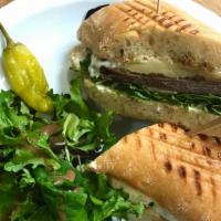 Roast Beef Panini · Thinly sliced all natural beef, grilled balsamic onions, melted provolone and Swiss cheese, ...
