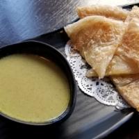 Roti · Thai-style bread served with green curry sauce.