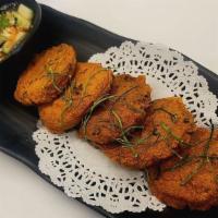 Fish Cake · Ground fish with fresh kaffir lime and red curry paste and fried.
