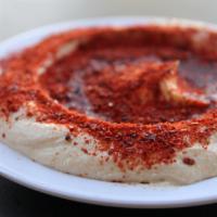 Middle Eastern Hummus · Topped with ground beef, sumac & cumin.