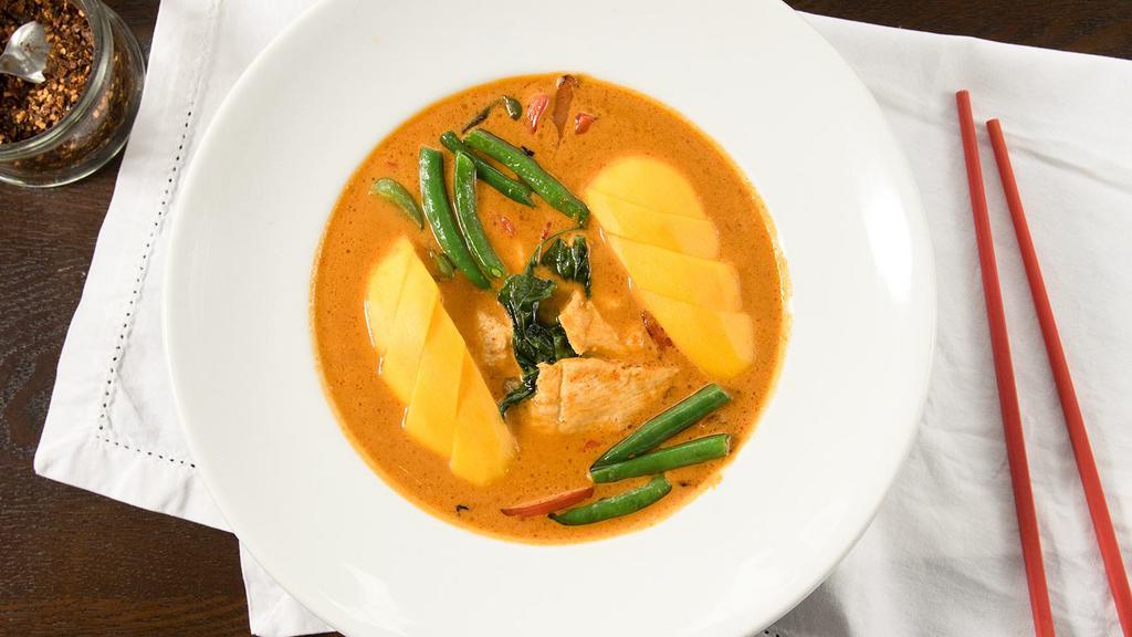 Mango Chicken Curry · Red curry simmered in coconut milk with chicken, green beans, bell pepper, chili, basil leaves and mango.