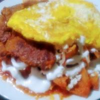 Chilaquiles · Fried tortilla with mild sauce and we add sour cream, fresh cheese, onion and chopped cilant...