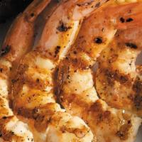 Fire-Grilled Jumbo Shrimp · Fire-grilled jumbo shrimp brushed with garlic butter served over a bed of rice.