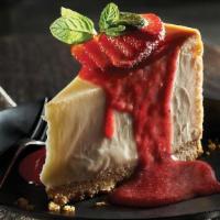 New York Style Cheesecake · Topped with sweet strawberry sauce.