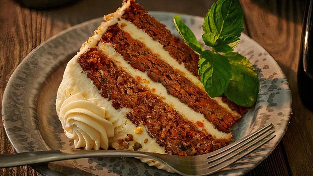 Spiced Carrot Cake · Slice of carrot cake, with pineapple and walnuts, a dash of vanilla and cinnamon, layered together with cream cheese frosting. . Contains nuts.