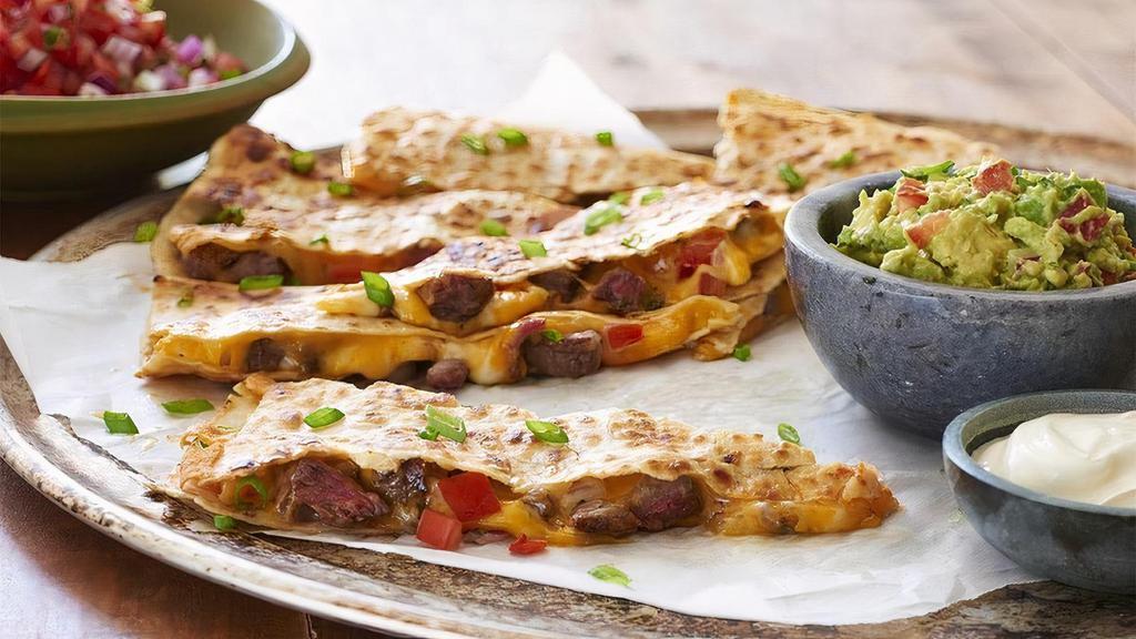 Steak Quesadilla · Grilled steak, fresh pico de gallo, Cheddar and Jack cheeses, served with guacamole and sour cream.