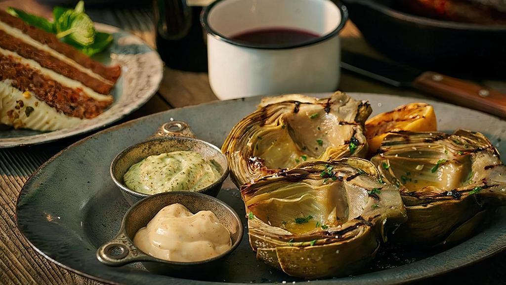 Grilled Artichoke · Served with our house-made lemon aioli and our signature basil pesto mayo for dipping.