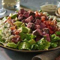 Steakhouse Cobb Salad · Crisp chilled greens tossed with our house vinaigrette and layered with fresh avocado, tomat...