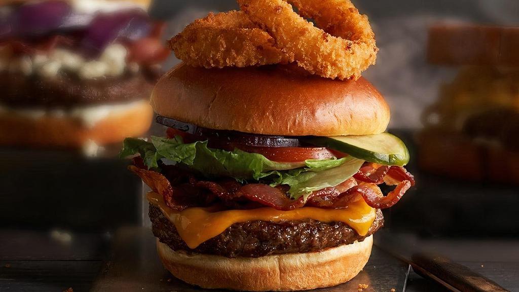 Steakhouse Bacon Cheeseburger · Signature item. Hand-formed, half-pound, Certified Angus Beef® ground chuck, stacked high with Applewood-smoked bacon, Cheddar cheese, lettuce, tomato, onion, house-made pickles, topped with onion rings. Served with French Fries.
