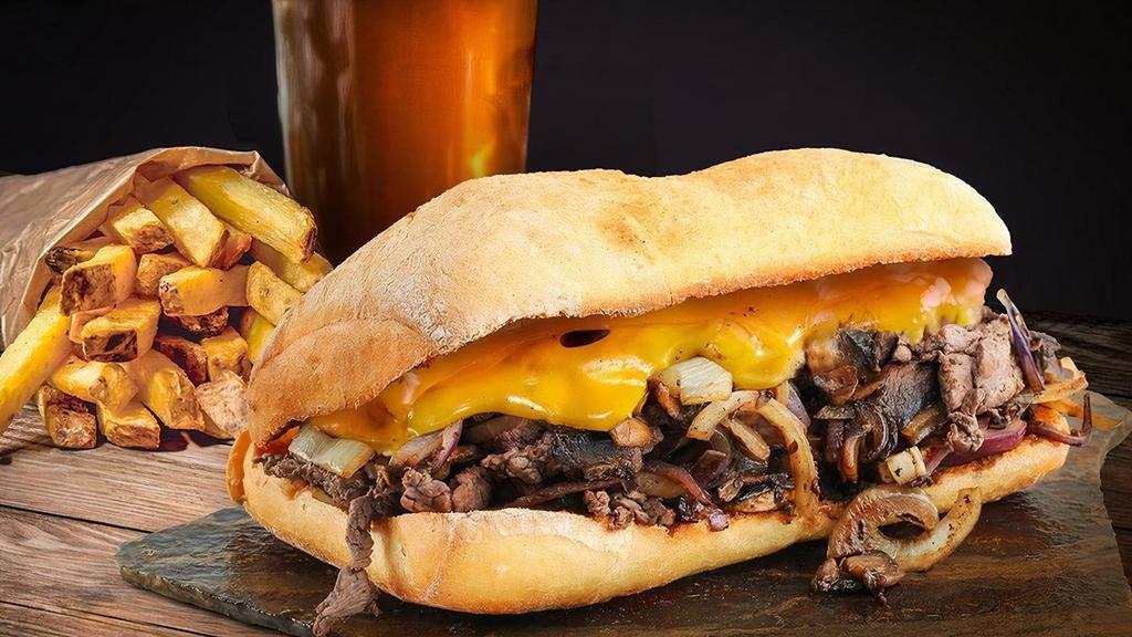 Filet Mignon Sandwich · Sliced filet mignon topped with sautéed onions, cheddar cheese, and house-made chipotle mayo. Served with French Fries.
