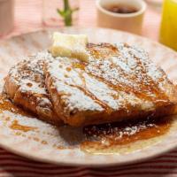 Brioche French Toast · brioche dipped in our french toast batter, griddled until golden brown. Served with syrup, b...