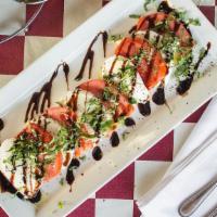 Insalata Caprese · Sliced roma tomatoes with fresh mozzarella cheese and fresh basil.