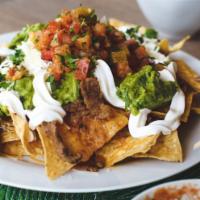 Super Nachos · Choice of protein, pinto beans, cheese, guacamole, sour cream, and pico de gallo.