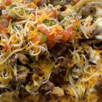 Carne Asada Fries · Large portion of French fries, topped with grilled steak, salsa fresca cheese, guacamole and...