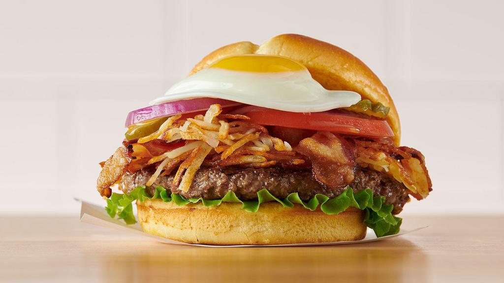 Hangover Burger · Shake off last night with a flame-grilled beef patty topped with crispy hash browns, Applewood smoked bacon, lettuce, tomatoes, pickles, red onions, and mayo topped with a sunny side-up egg. Served with choice of fries or a fresh garden salad.