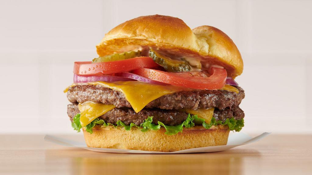 Famous Double Burger · Two patties, two slices of melted cheddar cheese, lettuce, tomatoes, red onions, and pickles, with Coco’s Special Sauce. Served with choice of fries, tots, fresh garden salad or thick-cut onion rings ($1 extra).