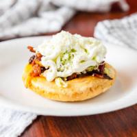 Sope · Fried tortilla sandwich with any meat, refried beans, lettuce, sour cream, and feta cheese