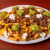 Asada Fries · Plate of fries with any meat, nacho cheese sauce, cheese, sour cream and guacamole