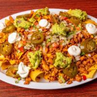 Super Nacho Plate · Nacho chips with nacho cheese sauce, any meat, jalapenos and pico de gallo, refried beans, s...
