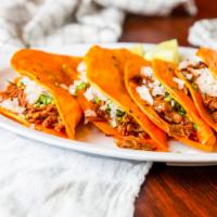 Tacos Barbacoa Plancha · Four marinated birria tacos with grilled onions, cilantro, and small birria soup