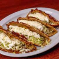 Tacos Quesadilla · Four crunchy burnt cheese tacos with potatoes, chorizo, lettuce, sour cream and cheese