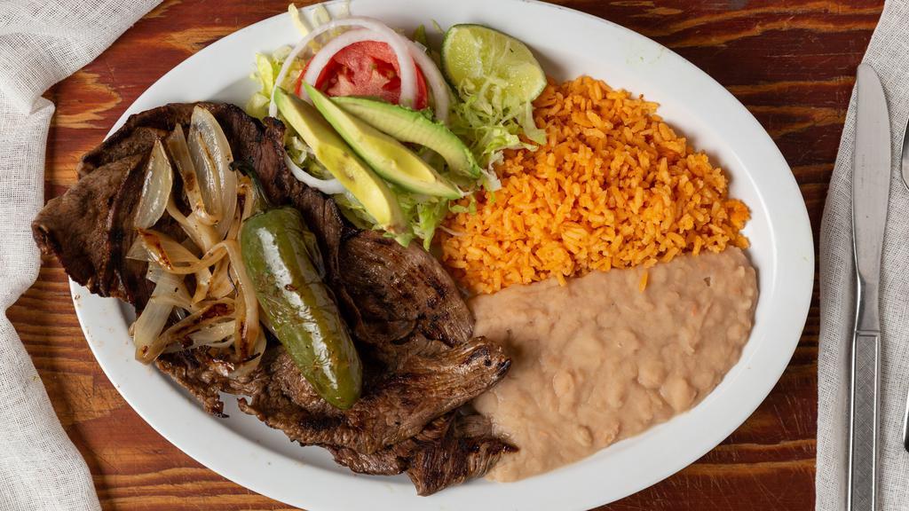Carne Asada Plato · Three asada steaks, small salad, grilled onions and grilled jalapeno, with rice and beans