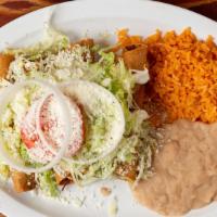 Taquitos Dorados · Four crunchy shredded chicken taquitos, a small salad with rice and beans