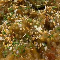 Baigan Bharta · Eggplant roasted in a clay pot and cooked with green onions, garlic, bell peppers, herbs and...