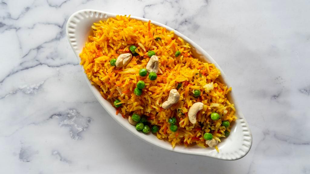 Saffron Rice · Saffron rice with green peas and cashews.