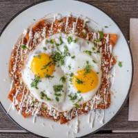 House Chilaquiles · Red or green salsa base, tortilla fritters, queso fresco, cilantro topped with two eggs cook...