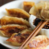 Pot Sticker · Vegan. Steamed dumplings stuffed with vegetables, pan fried with garlic. Served with sour so...