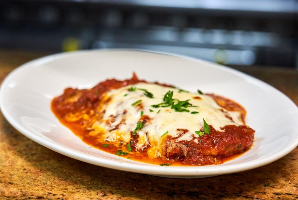 Veal Parmigiana · Breaded veal baked with marinara sauce and mozzarella cheese.