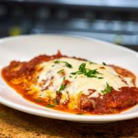 Veal Parmigiana · Breaded veal baked in marinara sauce and topped with mozzarella cheese.