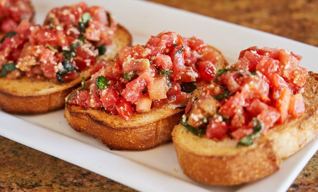 Small Bruschetta · Fresh cold tomatoes, basil and cheese on sliced baked bread. (4 Pieces)