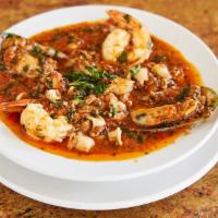 Cioppino · Jumbo shrimp, squid, mussels, clams, and scallops in a tomato sauce, served with salad and V...