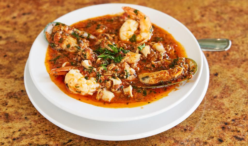 Cioppino · Jumbo shrimp, squid, mussels, clams, and scallops in a tomato sauce, served with salad and Visconti's garlic bread.