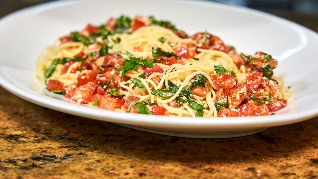 Spaghetti Di Campagnia · Spaghetti tossed with olive oil, fresh raw tomatoes, garlic, basil, and parmesan cheese. Tomatoes served cold.