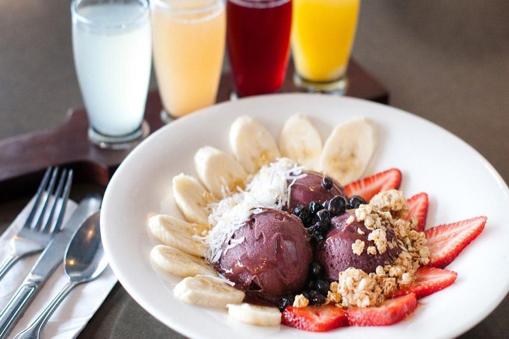 Acai Bowl · Acai berry sorbet topped with fresh strawberries, blueberries, bananas, granola, shredded coconut, and honey.